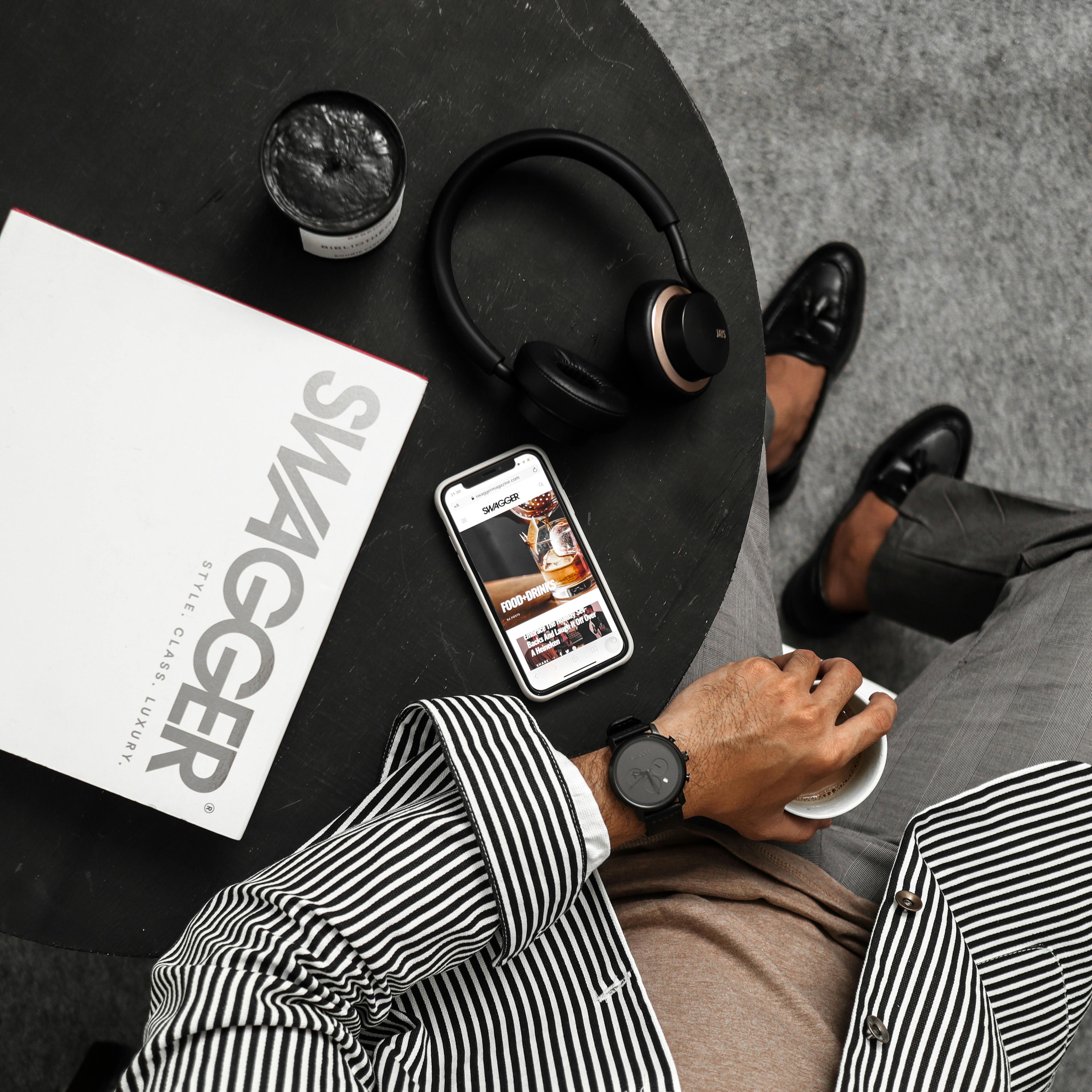 men sitting next to a table with accessories